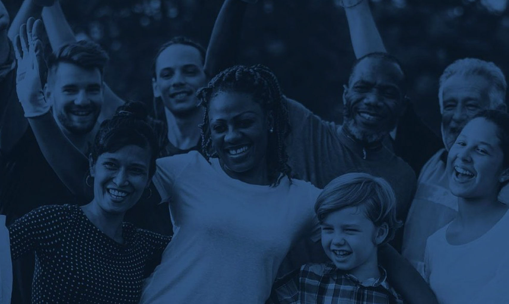 Group of diverse individuals smiling and celebrating, representing community engagement and unity, relevant to Wangard Partners' focus on residential development and public relations efforts.