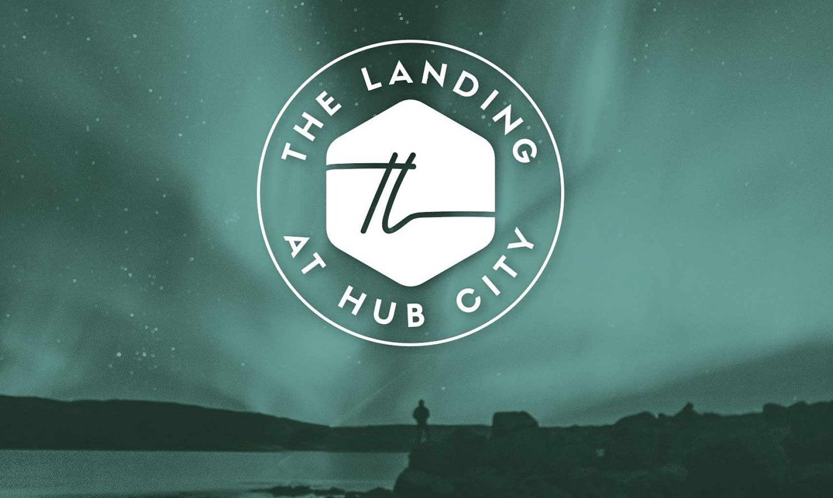 Logo of The Landing at Hub City, featuring a hexagonal design with the text "THE LANDING AT HUB CITY" in a modern font, representing Wangard Partners' new residential community project in Plymouth, Wisconsin.